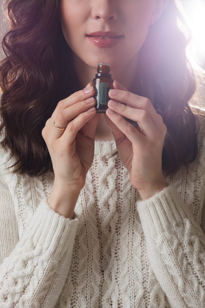 young caucasian model with long dark hair poses camera with hand near her face 2